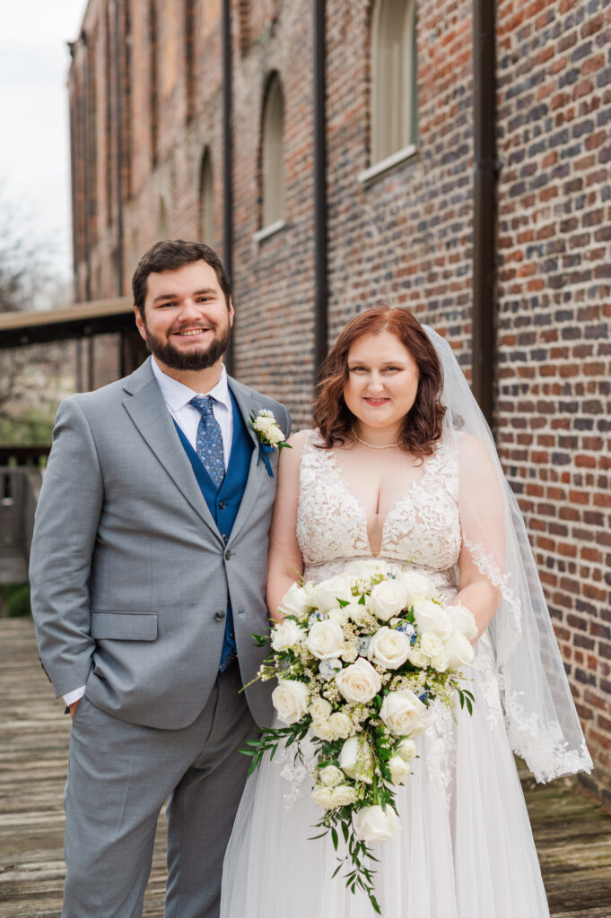 bride and groom smiling at camera