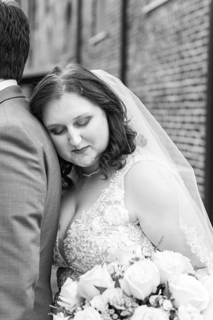 bride resting on groom's shoulder