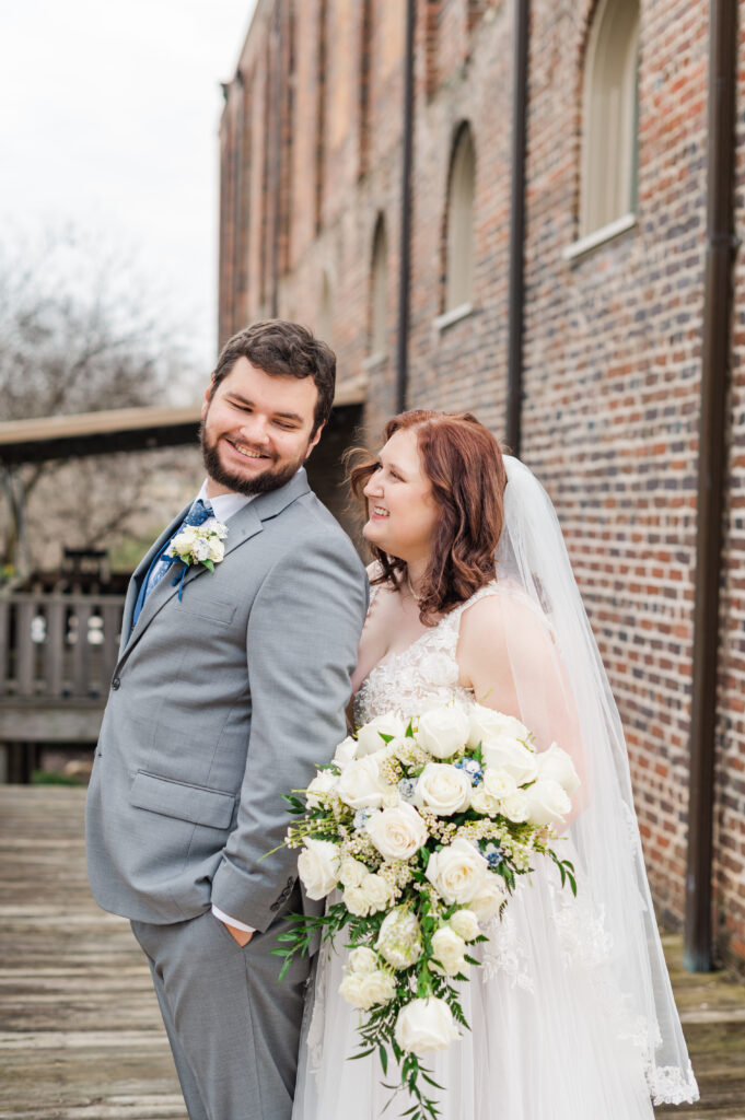 bride and groom smiling at each other