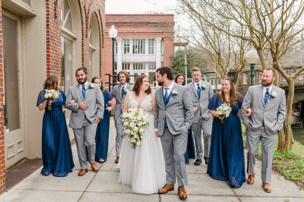 bride and groom with wedding party walking