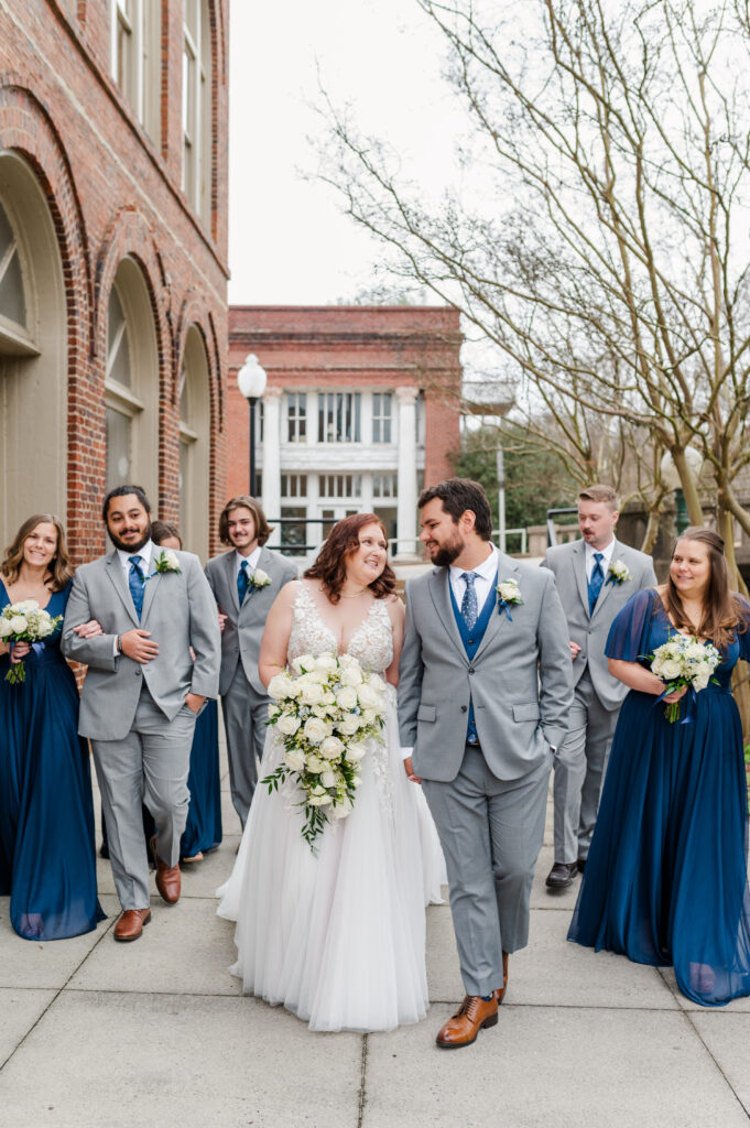 wedding party walking with bride and groom