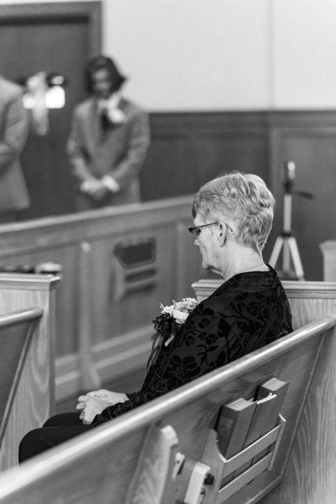 person sitting on pew