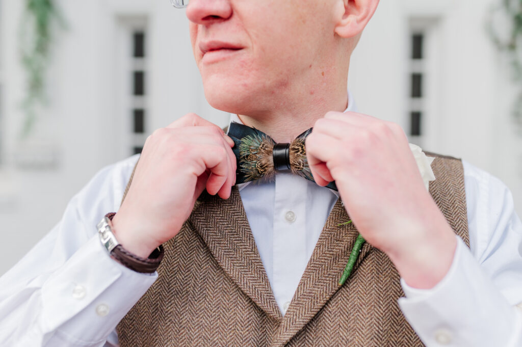 groom adjusting bowtie