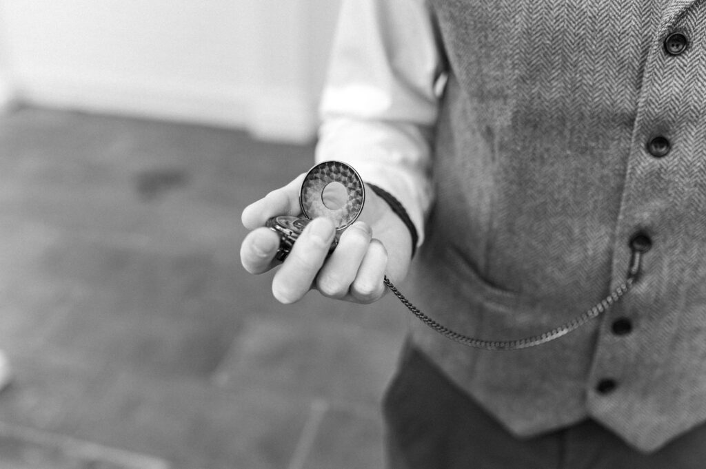 groom holding pocket watch