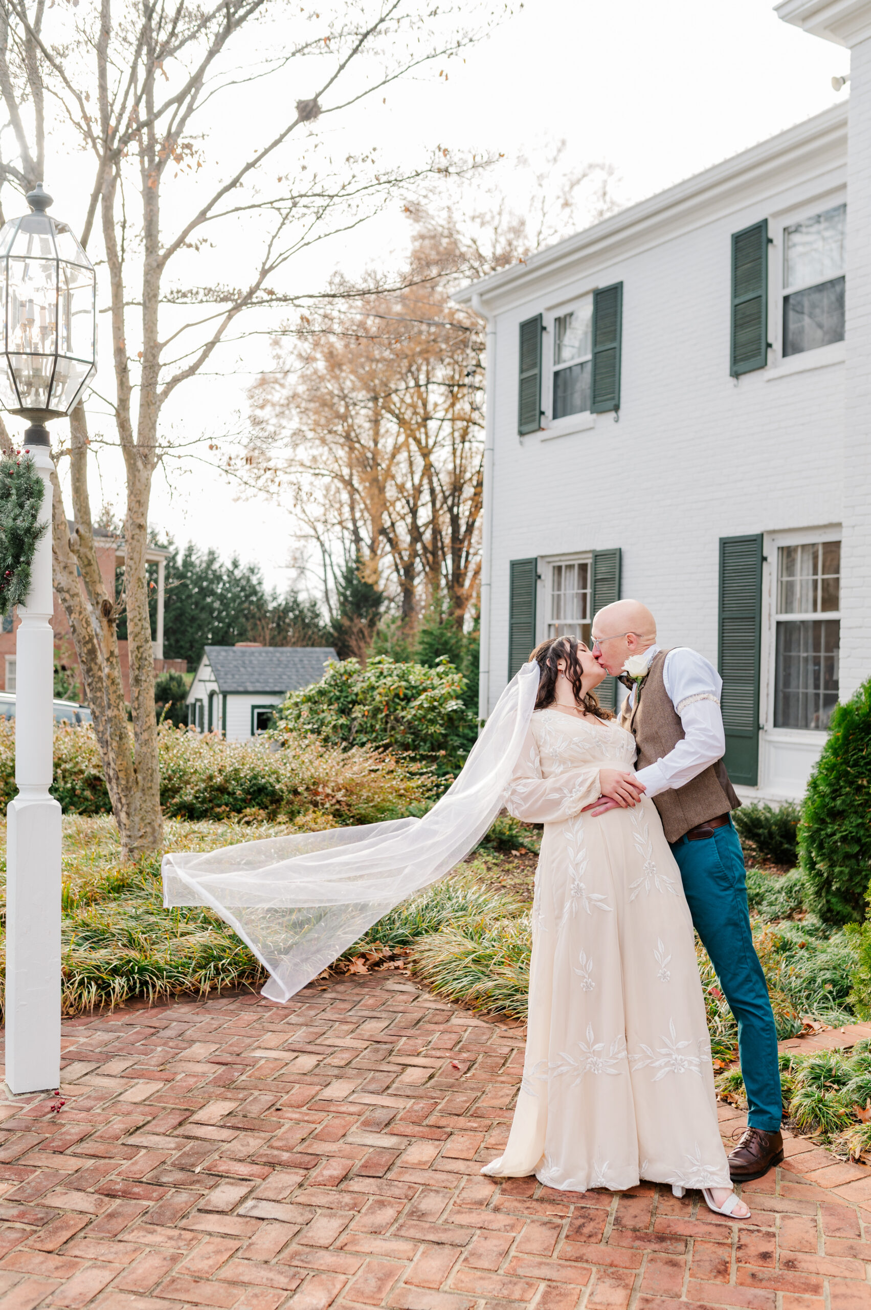 bride and groom kissing with veil