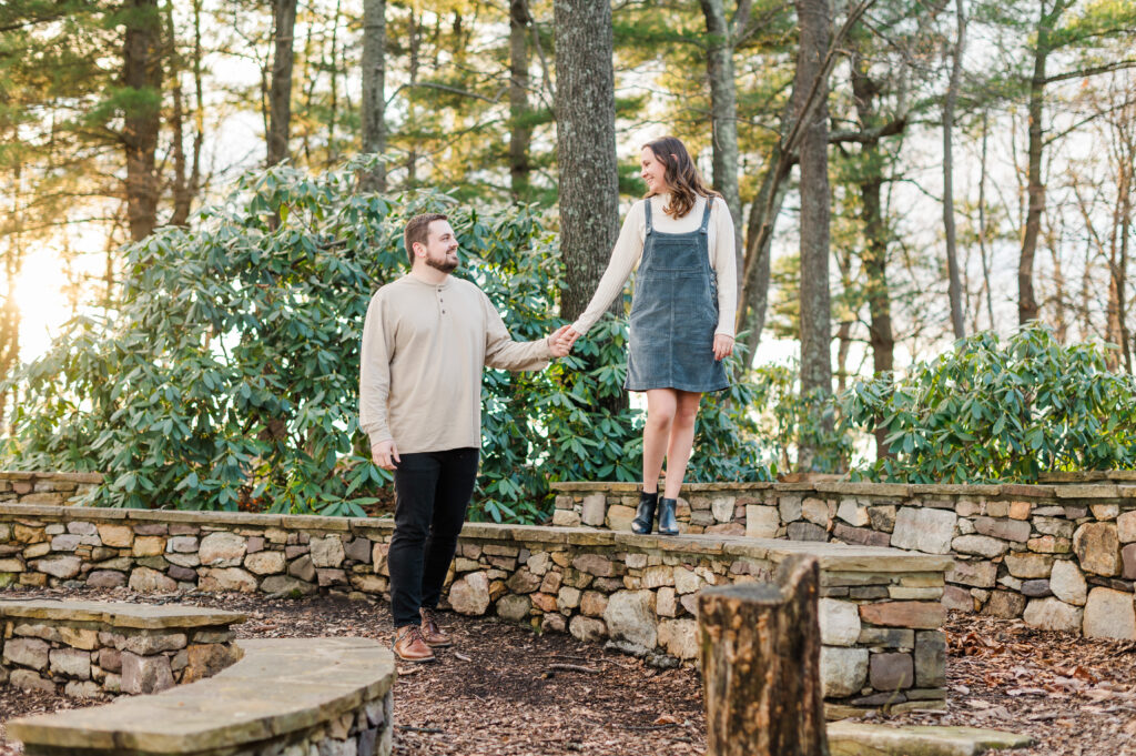 couple standing on rock wall