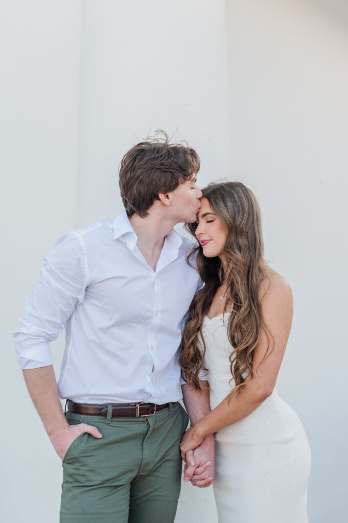 guy kissing girl's forehead