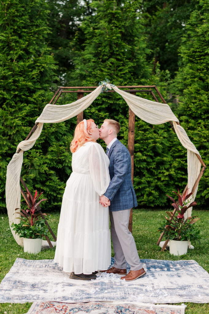 bride and groom first kiss