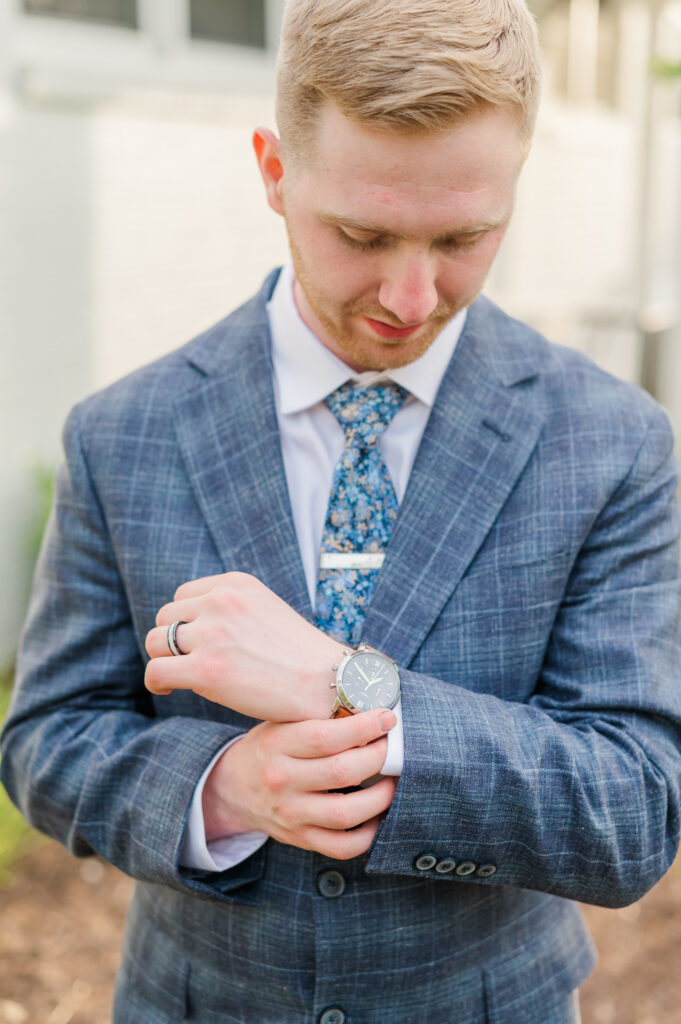 groom adjusting watch