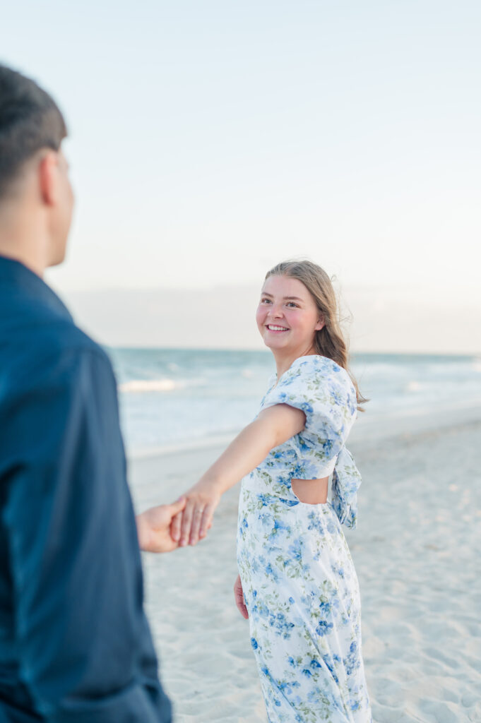 couple holding hands at topsail beach