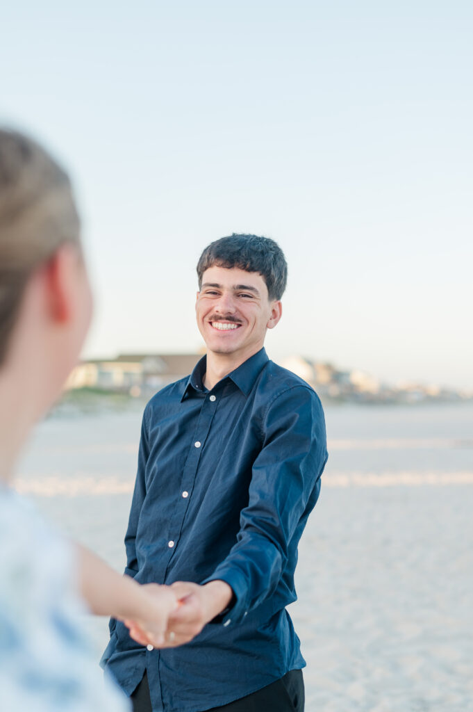 couple holding hands at topsail beach