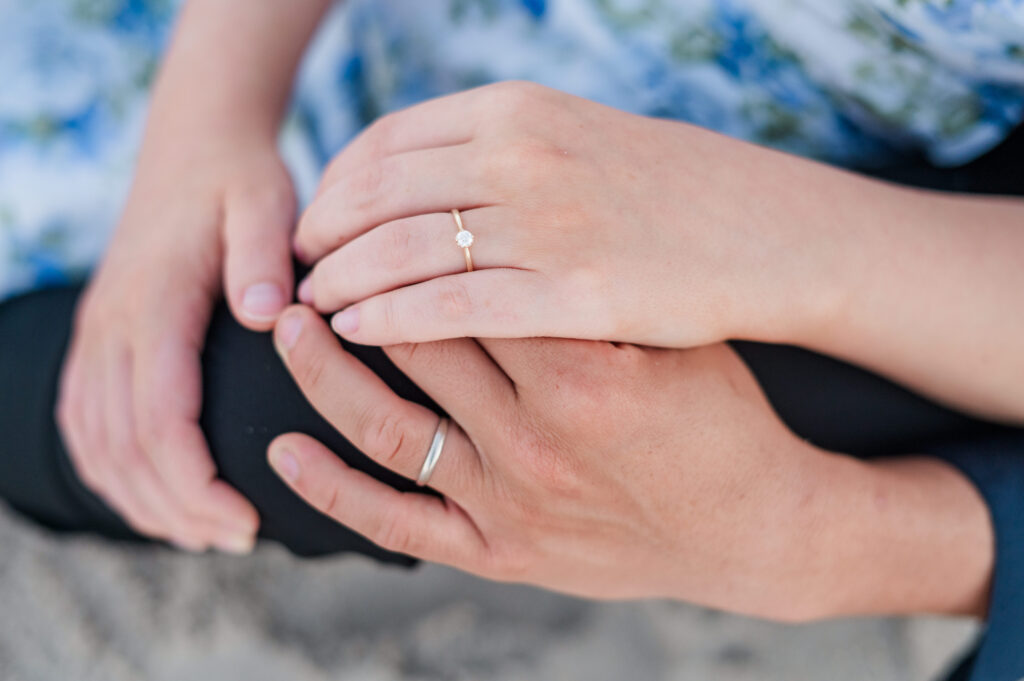 couple looking at wedding rings at topsail beach