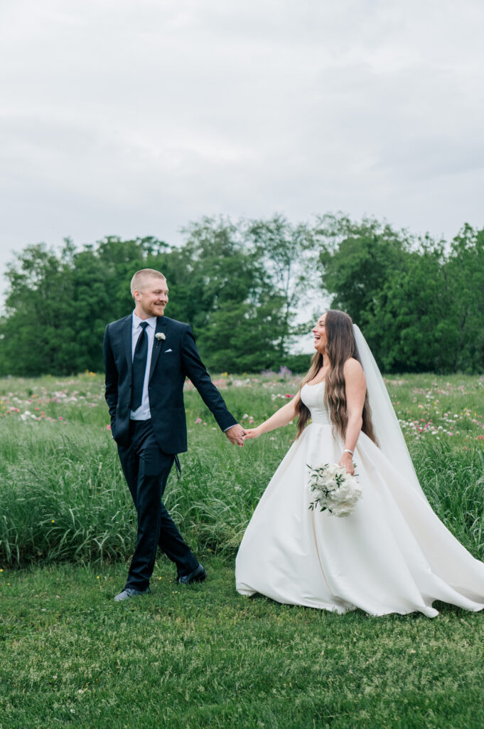 Bride and groom portraits flower field rainy walking