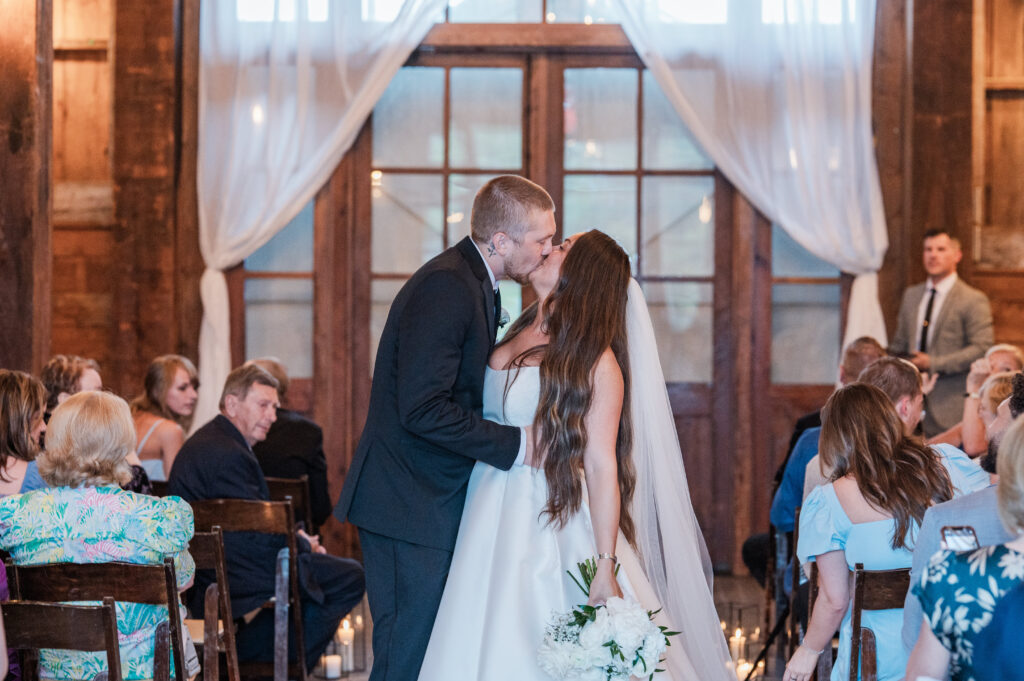 Indoor wedding ceremony first kiss