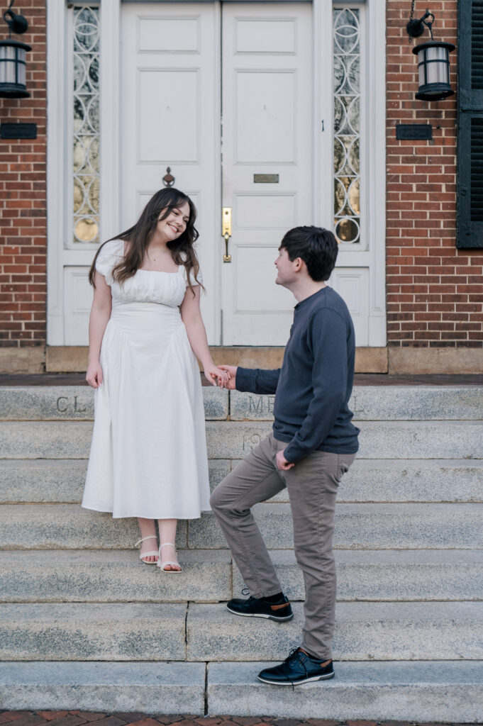 White columns brick building engagement photos