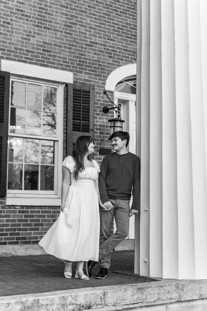 White columns brick building engagement photos